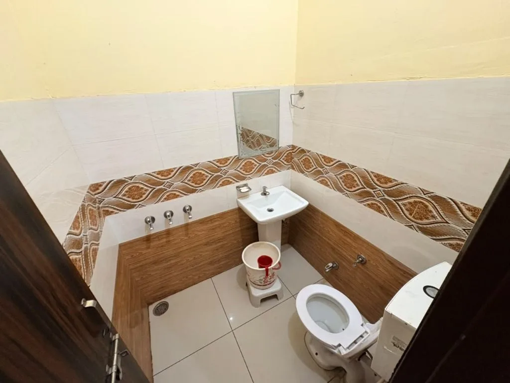 Clean attached bathroom with geyser at Hotel Jangid